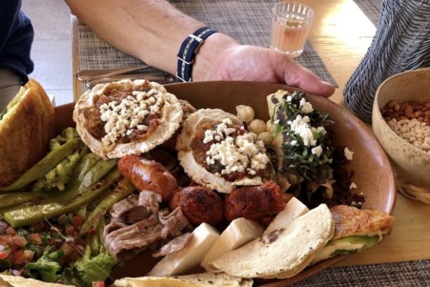 a person holding a plate of food