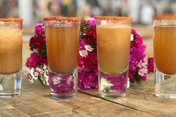 a close up of a glass of beer on a table