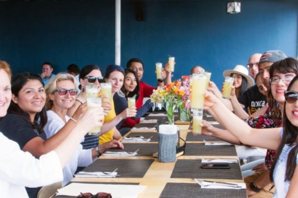 a group of people sitting at a table posing for the camera