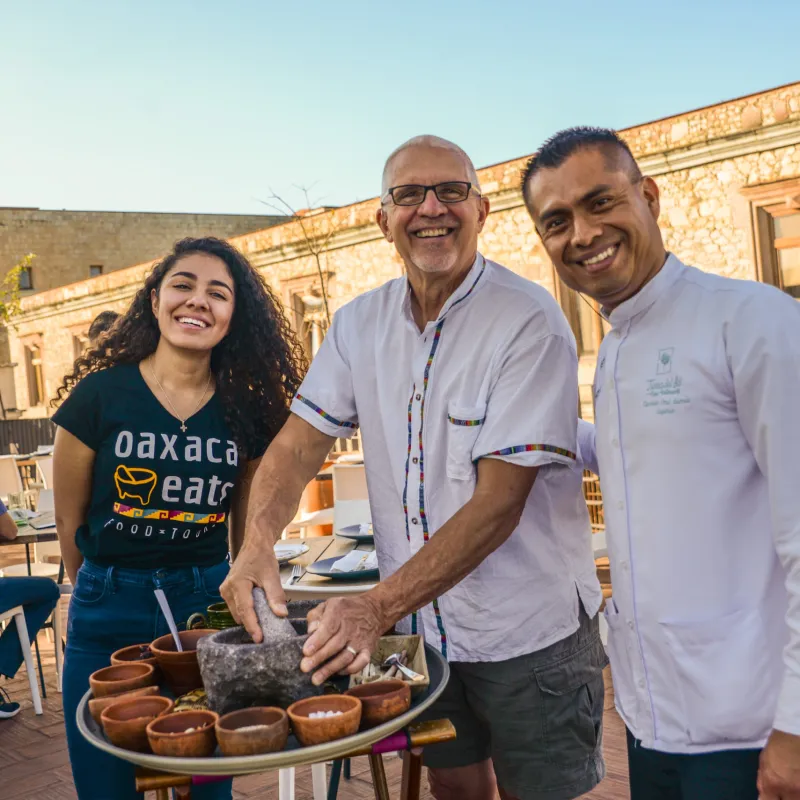 a man standing in front of a group of people posing for the camera