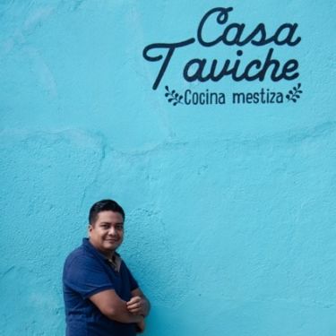 a person holding a sign posing for the camera