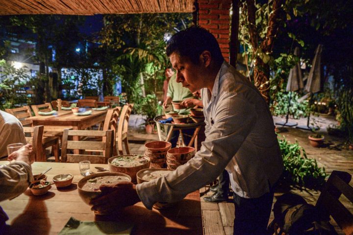 a man standing in front of a cake