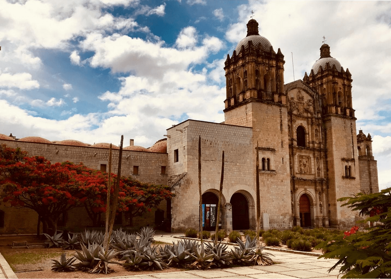 Weather in Oaxaca a church with a clock on the side of a building