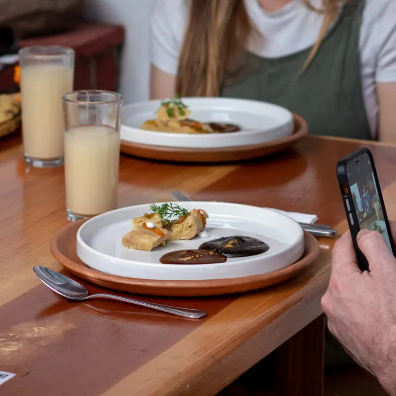 a man sitting at a table with a plate of food