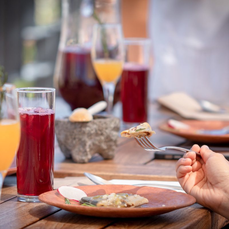 a person sitting at a table eating food